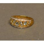 A 9ct Gold Pale Sapphire and Diamond Set Band Ring of pierced form