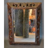 A Victorian Carved Oak Rectangular Cushion Mirror with pierced scroll frame, 112cm by 82cm