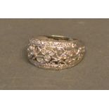 A 9ct White Gold Diamond Encrusted Ring of pierced band form