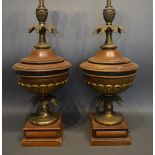 A Pair Of Early 20th Century Table Lamps, Each With A Shaped Wooden Body, with gilt metal mounts,