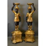 A Pair Of Blackamoor Floor Standing Torchere Of Figural Form with square stepped bases, 151cm tall