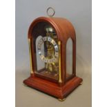 A Reproduction Mahogany Case Mantle Clock By Hermle, West Germany, of skeleton clock form, with