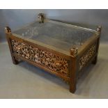 A Chinese Hard Wood Rectangular Opium Table With A Glass Top above a gilded pierced frieze, raised