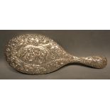 A Continental White Metal Hand Mirror Of Oval Form