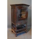 A Late 18th Early 19th Century French Oak Side Cabinet with a glazed door above a drawer with