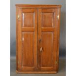 A George III Oak Hanging Corner Cabinet with two moulded doors