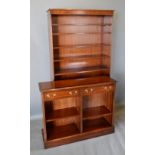 A Reproduction Mahogany Bookcase With An Arrangement Of Shelves upon a plinth base, 100cm wide, 30cm
