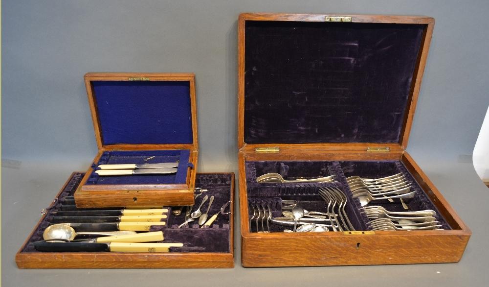 A Collection Of Silver Plated Flat Ware Housed Within An Oak canteen cabinet