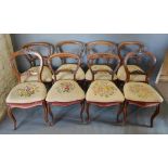 A Set Of Six Victorian Rosewood Balloon Back Dining Room Chairs, each with a shaped rail back