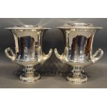 A Pair Of Silver Plated Wine Coolers Each With Shaped Handles with insert upon circular pedestal