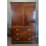 A 19th Century Mahogany Press Cupboard, The Moulded Cornice above two panel doors enclosing a