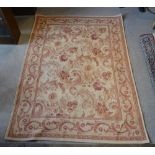 An Aubusson Type Woollen Rug With An All Over Foliate And Scroll Design within multiple borders,