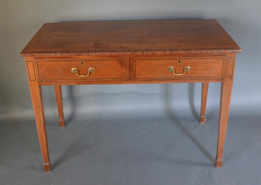 A 19th Century Mahogany Side Table The Crossbanded Inlaid Top above two drawers with brass