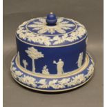 A Jasper Ware Cheese Dish and Cover decorated in relief with Classical Figures, 27 cms diameter