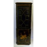 A Lacquered Standing Corner Cabinet With An Astragal Glazed Top above a door, raised upon a