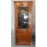 A George III Mahogany Standing Corner Cabinet, The Moulded Cornice above an astragal glazed door