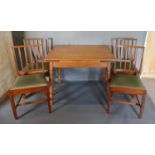 A Set Of Four Mahogany Dining Chairs With Drop In Seats, together with an extending dining table.
