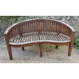 A Teak Garden Bench Of Serpentine Form With Square Legs, together with a rectangular refectory style