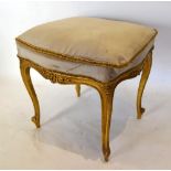 A French Gilt Wood Stool Of Serpentine Form, The Padded Top above a scroll carved frieze, raised