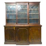 A George III Mahogany Breakfront Book Case, The Moulded Top above three arched glazed doors, the