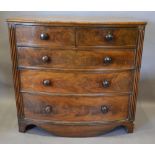 A Victorian Mahogany Bow Fronted Chest Of Two Short and three long drawers with knob handles, raised