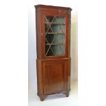 A 19th Century Mahogany Standing Corner Cabinet, The Moulded Cornice above an astragal glazed door