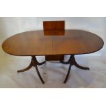 A Mahogany Extending Dining Table, The Reeded Top Above Twin End Supports with reeded legs, brass