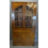 A 19th Century Mahogany Library Bookcase With Two Arched Astragal Glazed Doors enclosing shelves,