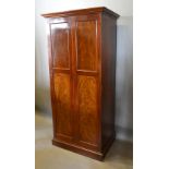 An Edwardian Mahogany Hall Cupboard, The Moulded Cornice above two moulded panelled doors, raised