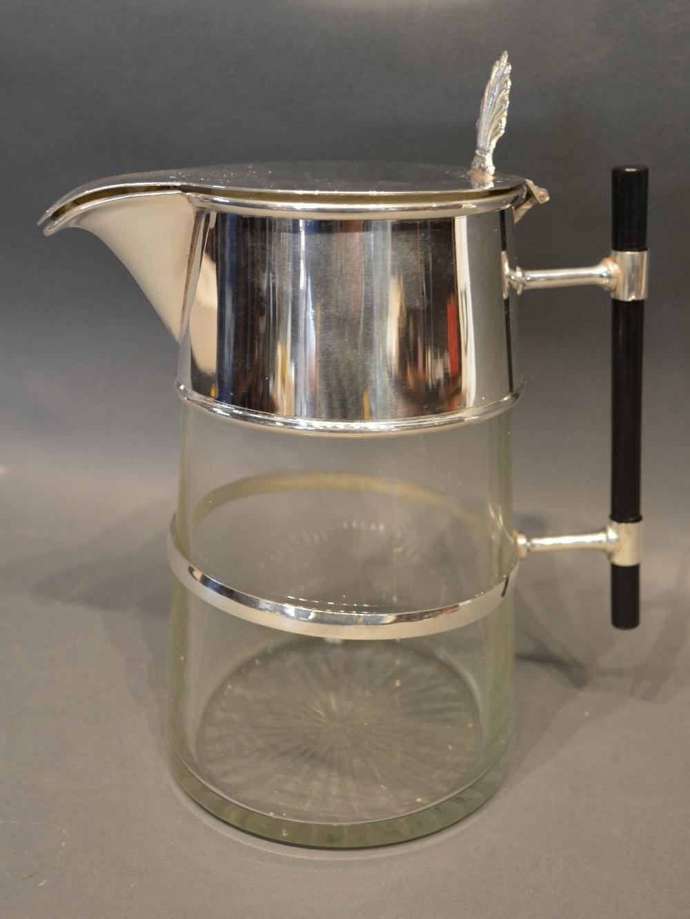 A Silver Plated And Cut Glass Claret Jug In The Style Of Christopher Dresser with stylized handle,