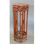 A Chinese Hardwood Jardiniere Stand with a pierced frieze raised upon shaped legs with low feet,