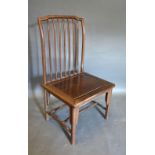 A Chinese Hardwood Side Chair with a spindle back above a panel seat raised upon turned legs with