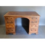 A 19th Century Mahogany and Crossbanded Twin Pedestal Desk, the tooled leather inset top above eight