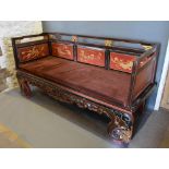 A Late 19th Early 20th Century Chinese Lacquered Day Bed, the pierced back above a panel seat and