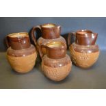 A Doulton Lambeth Stoneware Harvest Jug together with three other similar Doulton Stoneware