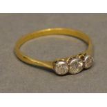 An 18 Carat Yellow Gold Three Stone Diamond Ring set with three diamonds within a pierced setting