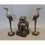 A 19th Century Chinese Bronze Censer in the form of a Dog of Fo, together with two similar patinated