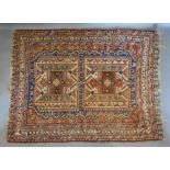 A North West Persian Woollen Rug with two central medallions within an allover design on a blue,