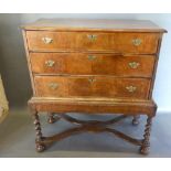A George II Walnut Chest On Stand, the moulded crossbanded top above three drawers with brass