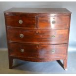A 19th Century Mahogany Bow Fronted Chest Of Two Short And Two Long Drawers with circular brass