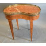 A French Kidney Shaped Low Table, the rouge marble and brass galleried top above an inlaid frieze