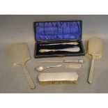 A Birmingham Silver Backed Three Piece Dressing Set, together with a silver handled shoe horn, a