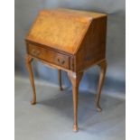 An Early 20th Century Queen Anne Style Burr Walnut Bureau, the fall front above a frieze drawer,