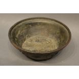 An 18th Century Chinese Bronze Bowl decorated with fish and bearing script, 13.5cm diameter