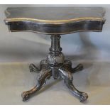 A Victorian Ebonised and Gilded Serpentine Card Table, the hinged top enclosing a baize lined