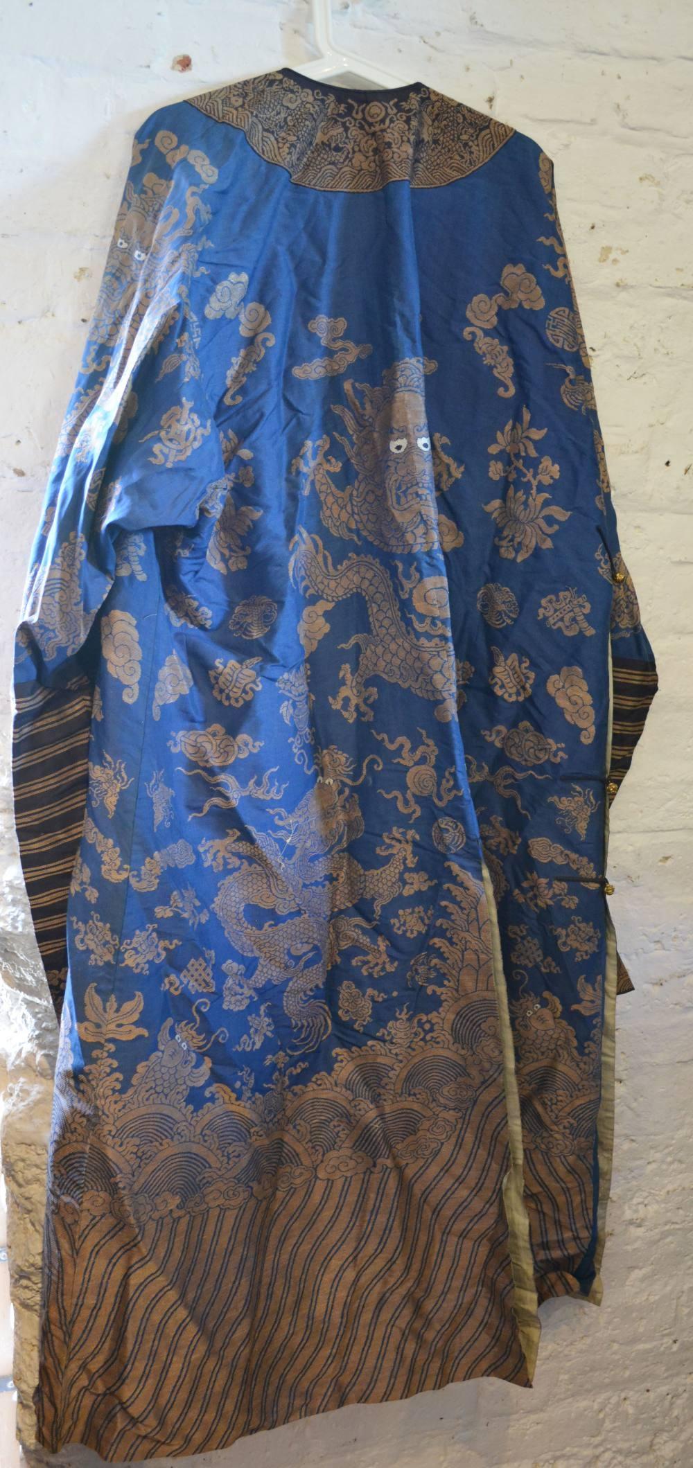 A Chinese Embroidered Kimono decorated with serpents amongst waves in gold thread upon a blue ground - Image 2 of 7