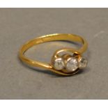 An 18 Carat Yellow Gold Three Stone Diamond Ring, the three diamonds mounted in a crossover setting