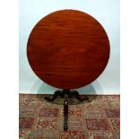A George III Mahogany Tilt Top Table, The Circular Top Above A Turned Center Column and