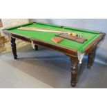 A Billiards Dining Table by Riley, the top in four sections above a baize on slate playing