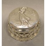 A Sterling Silver and Cut Glass Dressing Table Bottle, the top decorated with a lady golfer, 5cm